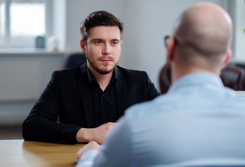 Confident young man attending job interview