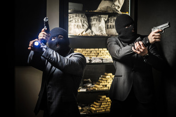 Two ardmed men robbing a bank