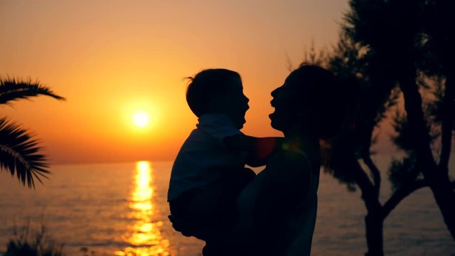 A woman with a child in the light of sunset