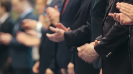 Business people standing in the row at the conference - clapping their hands - applause