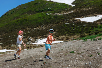 children walk in the mountains in summer.