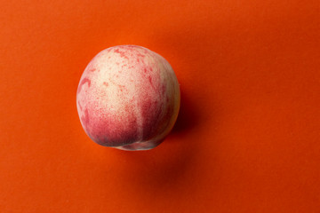 one peach on a bright background