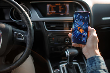 Handsome man using mobile phone while driving.
