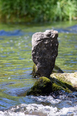 balanced stone in the riverbed