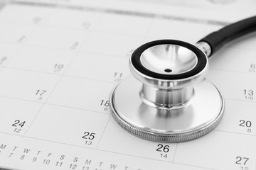 Regular medical examination concept, stethoscope on calendar