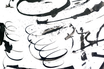 Black abstract brush strokes and splashes of paint on paper. Grunge art calligraphy background