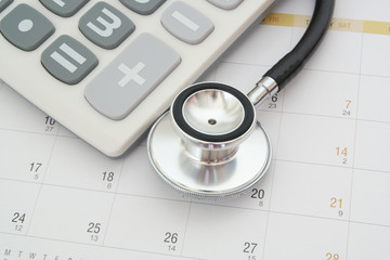 Medical examination concept,  stethoscope and calculator on calendar