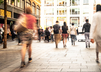 Motion blurred people on busy city street