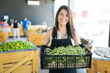 Business Owner Carrying Organic Fresh Vegetables At Store