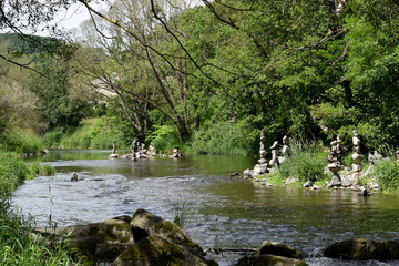 balanced stone towers in the river