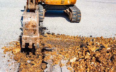 mini excavator equipped with a very narrow bucket to perform excavations of small width in the...