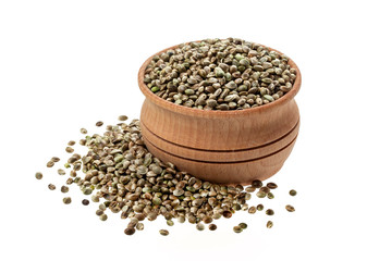 Hemp seeds in wooden bowl isolated on white background, close up
