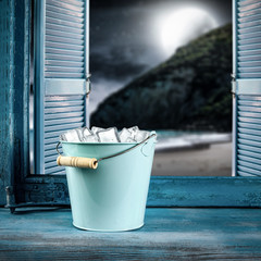 Window sill background with metal container of ice cubes and free space for your decoration. Summer time. 