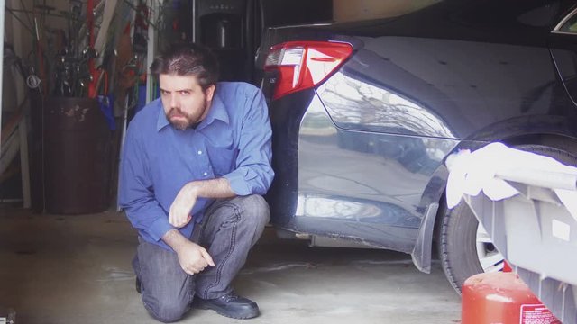 paranoid man hiding in garage