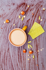 Coffee cup, chocolate with matcha tea, hazelnuts, cocoa powder and cardamon