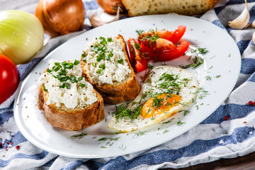 Breakfast - fried egg, toasts and vegetable salad