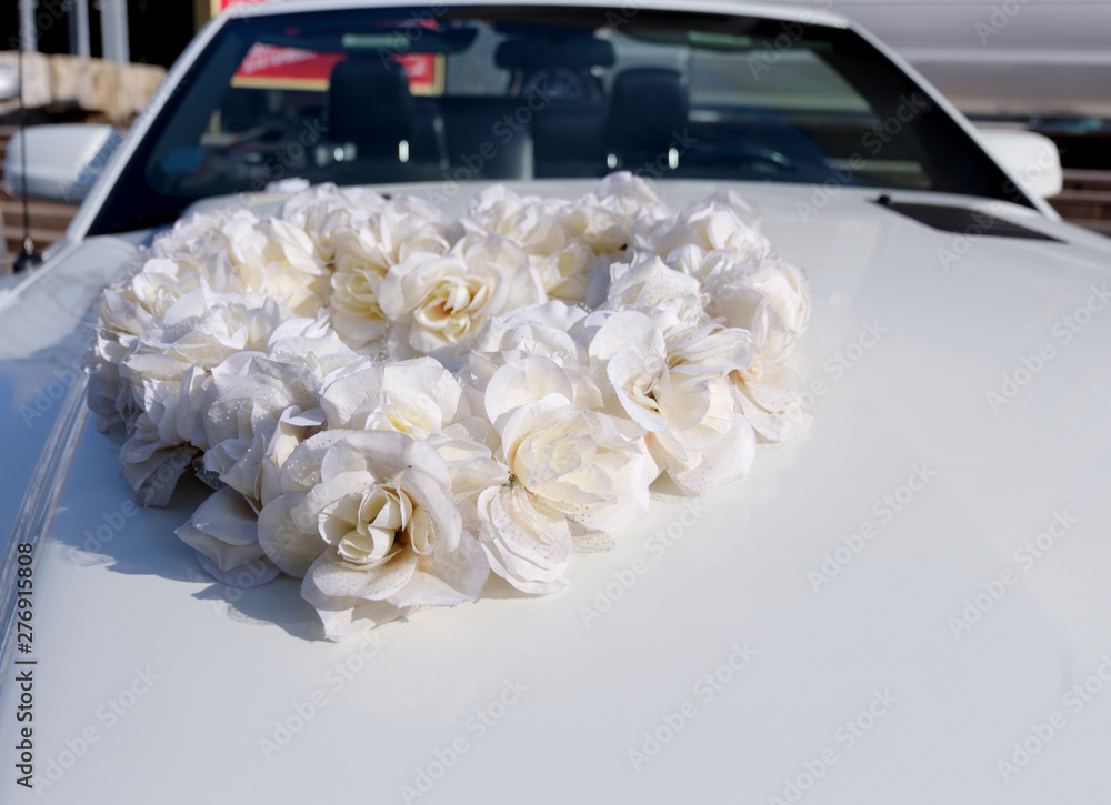 Wall mural white car decorated with a heart of the flowers