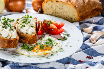 Breakfast - fried egg, toasts and vegetable salad