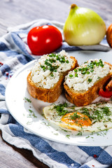 Breakfast - fried egg, toasts and vegetable salad