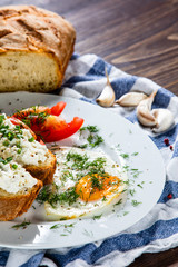 Breakfast - fried egg, toasts and vegetable salad