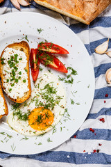 Breakfast - fried egg, toasts and vegetable salad