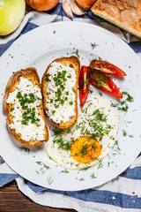 Breakfast - fried egg, toasts and vegetable salad