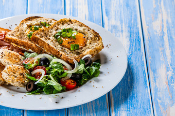Breakfast - toasted bread with fried egg, bacon and vegetables