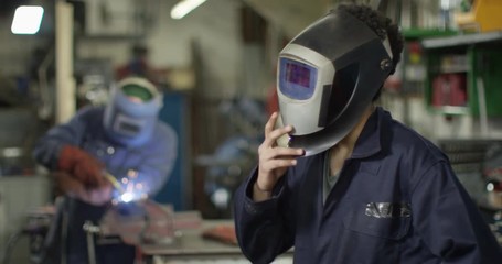 4K Portrait young attractive industrial worker with serious, sexy expression. Slow motion.