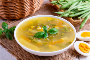 Fresh vegetable soup made of green bean, pea, carrot, potato in bowl