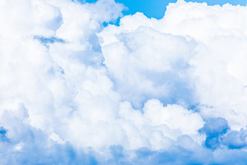 The vivid sky or heaven background with white and blue clouds under the sun rays