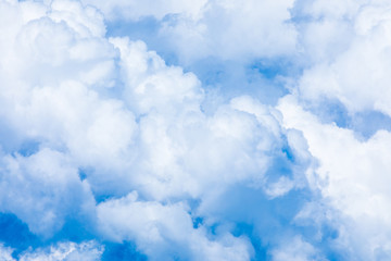 The vivid sky or heaven background with white and blue clouds under the sun rays