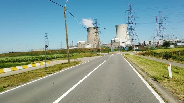 POV driving to Doel Nuclear Power Station with smoking cooling towers