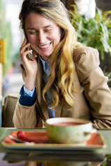 Happy smiling woman talking on the phone