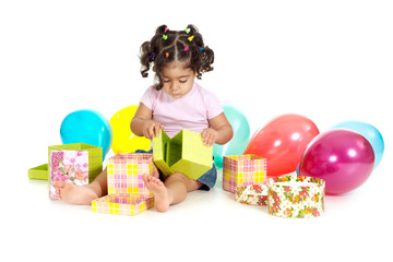 Portrait of little girl with balloons and gifts on a white background