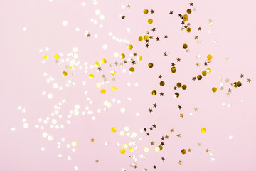 Gold Stars Glitter Confetti on pink background. Festive backdrop