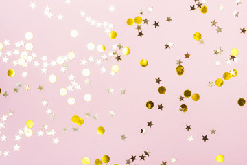 Festive background with Gold Stars Glitter Confetti on pink background