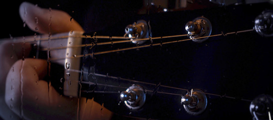 musician playing guitar at studio behind the glass with water drops