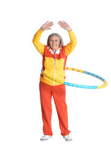 Portrait of senior woman posing with hoop on white background