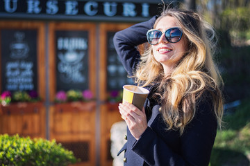 Happy caucasian blonde girl drinking