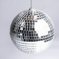 closeup .hand holding a mirror ball.isolated on gray background