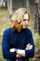 Portrait of a young man with long hair and beard