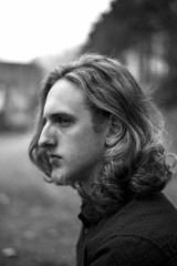 Black and white portrait of a young caucasian man with long hair
