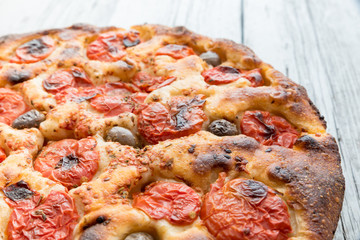 Focaccia typical of Bari Italy with tomatoes and olive