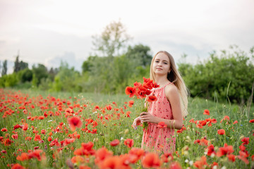 Naklejka na ściany i meble Ukrainian Beautiful girl in field of poppies and wheat. outdoor portrait in poppies