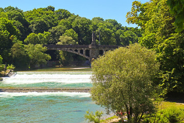 Munich, summer view of Isar river with the rapids and Praterinsel island from the city promenade