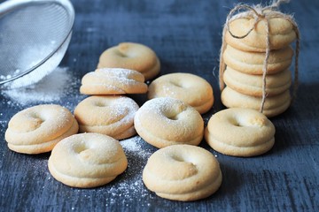Homemade cookies tied with rope. Wooden background, close-up.