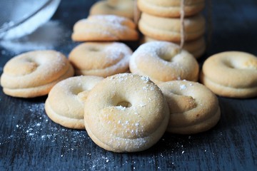 Homemade cookies tied with rope. Wooden background, close-up.