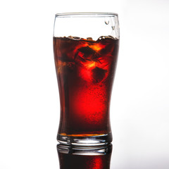 glass of cola, lemonade with ice on a white background