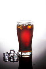 glass of cola, lemonade with ice on a white background