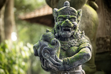 Statues of  demons or  gods at temple in the Monkey Forest Sanctuary